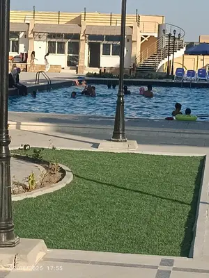 a pool with people swimming in the water at isis MARINA in Hurghada