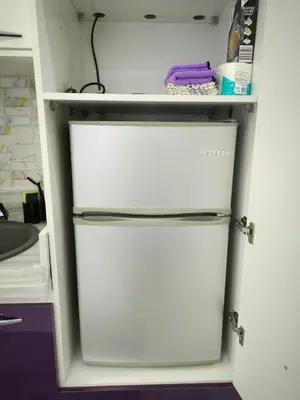 a white refrigerator in a kitchen with a shelf at Hurghada Chill Out Home in Hurghada