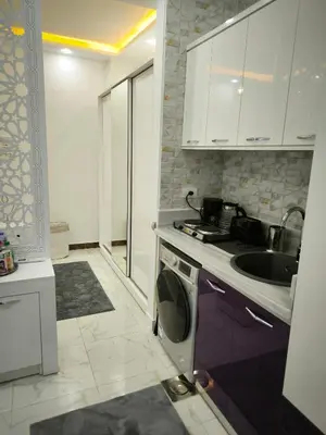 a kitchen with a sink and a washing machine at Hurghada Chill Out Home in Hurghada