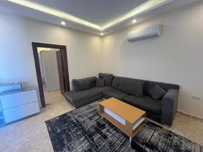 a living room with a couch and a coffee table at Mirage Bay Aqua Park Apartments in Hurghada
