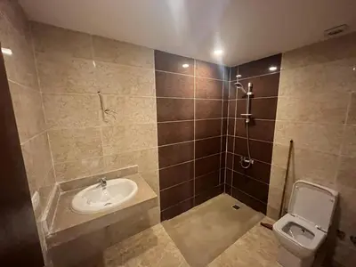 a bathroom with a sink and a toilet at Mirage Bay Aqua Park Apartments in Hurghada