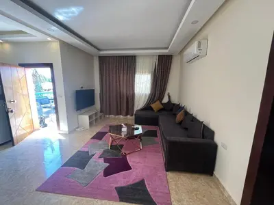 a living room with a couch and a table at Mirage Bay Aqua Park Apartments in Hurghada