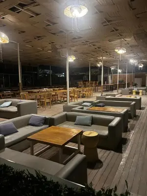 a restaurant with couches and tables and tables and chairs at Luxury Apartment in Hurghada