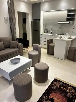 a kitchen and a living room with a table and chairs at Luxury Apartment in Hurghada