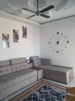 a living room with a couch and a clock on the wall at Apartment sea view in Hurghada