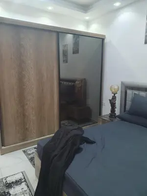 a bedroom with a bed and a sliding glass door at Apartment sea view in Hurghada