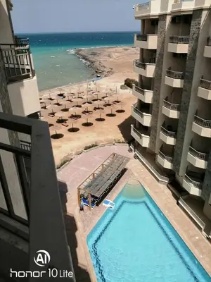 a view of the beach from the balcony of a hotel at La quinta hights in Hurghada