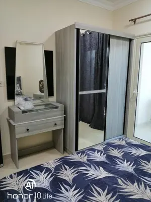 a bedroom with a bed and a dresser with a mirror at La quinta hights in Hurghada