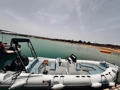 a boat is docked in the water on a river at Wave Dancer in Hurghada