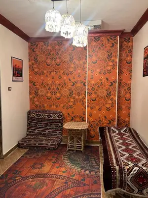 a living room with an orange wall at Aswan House center in Aswan