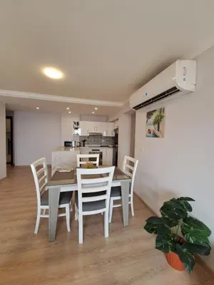 a kitchen and dining room with a table and chairs at Tawaya Sea View 2 bedrooms in Hurghada