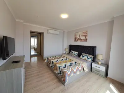 a bedroom with a bed and a flat screen tv at Tawaya Sea View 2 bedrooms in Hurghada
