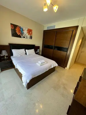 a bedroom with a large bed with a wooden headboard at El-Gouna in Hurghada