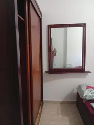 a mirror sitting on a wall next to a room at شقه للإيجار مكيفه in Hurghada