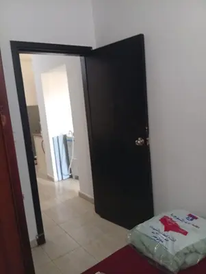 a room with a black door and a room with a bed at شقه للإيجار مكيفه in Hurghada