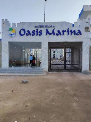 a building with a sign that reads oasis marina at Oasis Resort Compound in Hurghada