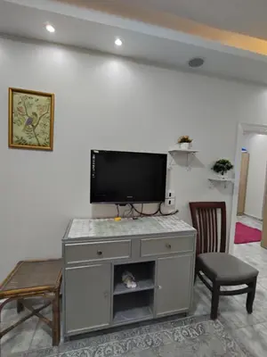 a entertainment center with a flat screen tv in a living room at Oasis Resort Compound in Hurghada