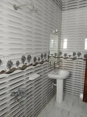 a bathroom with a sink and a glass shower at Essa Apartment in Safaga