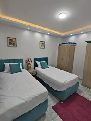 two beds in a room with twoermottermott at Oasis marina الاحياء in Hurghada
