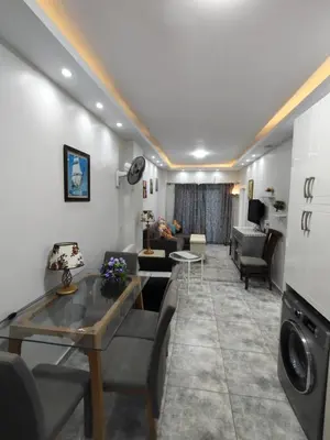 a living room with a couch and a table at Oasis marina الاحياء in Hurghada