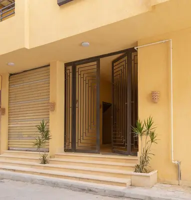 a front door of a building with some stairs at Bayt Hassan S2 - Cosy 1 bedroom apartment in Hurghada