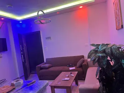 a living room with a couch and a table at Elegant Stay Apartment in Hurghada
