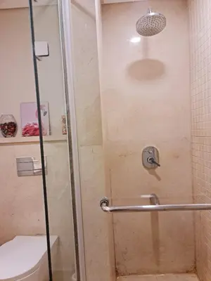 a shower with a glass door next to a toilet at 1 bedroom in mangroovy El gouna in Hurghada