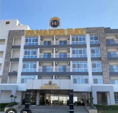 a building with a sign on top of it at Fanadir bay resort in Hurghada