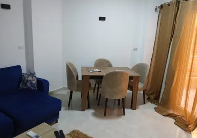 a living room with a wooden table and chairs at Fiesta Beach Resort in Hurghada