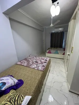 a room with two beds and a mirror at شقة فندقية صف أول بحر وبول in Hurghada