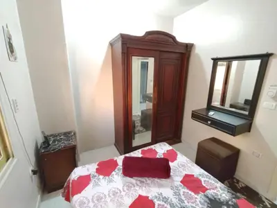 a bedroom with a bed with a dresser and a mirror at flat in Hurghada Sheraton Metro street in Hurghada