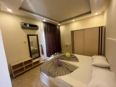 a bedroom with a bed with a tennis ball on it at Mirage Bay Apartments in Hurghada