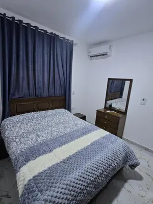 a bedroom with a bed and a dresser and a mirror at Nada C206 in Hurghada