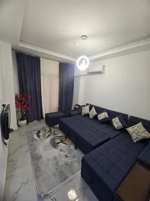 a living room with a blue couch in a room at Nada C206 in Hurghada