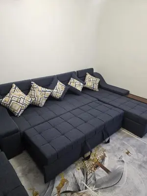 a black couch with pillows in a living room at Nada C206 in Hurghada