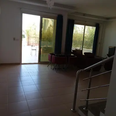a living room with a couch and a table and chairs at George Villa in Hurghada