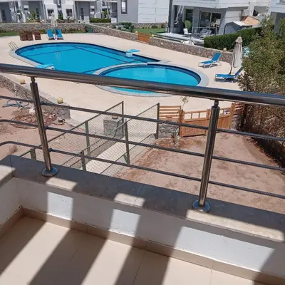 a staircase with a railing next to a swimming pool at George Villa in Hurghada