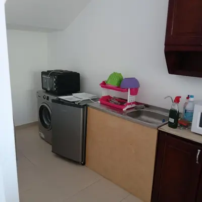 a kitchen with a washing machine and a microwave at George Villa in Hurghada
