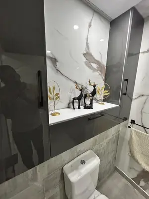 a bathroom with a toilet and some figurines on a shelf at Scandic Beach Luxury in Hurghada