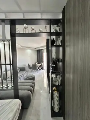 a room with a loft bed with couches and a table at Scandic Beach Luxury in Hurghada