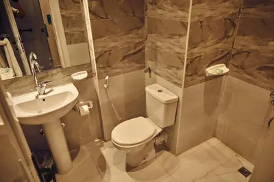 a bathroom with a toilet and a sink at Town Hotel- Hurghada in Hurghada
