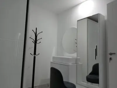 a white room with a mirror and a chair at Fanadir bay Al Ahyaa in Hurghada