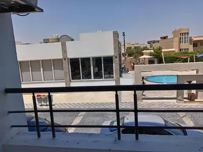 a balcony with a car parked in front of a building at Fanadir bay Al Ahyaa in Hurghada