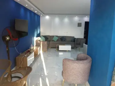 a living room with a couch and chairs at Fanadir bay Al Ahyaa in Hurghada
