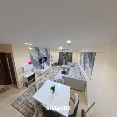 a living room with a white table and chairs at New chalet with sea view and private beach access 82m in Hurghada