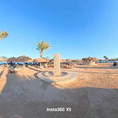 a beach with umbrellas and tables and chairs at New chalet with sea view and private beach access 82m in Hurghada