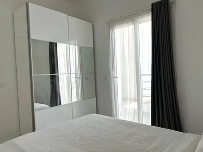 a bedroom with a mirror and a bed and a window at Aqua Palms 2 bedroom apartment - Hurghada Egypt in Hurghada