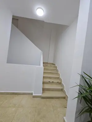 a staircase in a white room with a white wall at Hatschepsut hous in ‘Ezbet Abu Ḥabashi