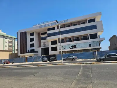 a building on a street with cars parked in front of it at Red Sea Sanctuaries in Hurghada