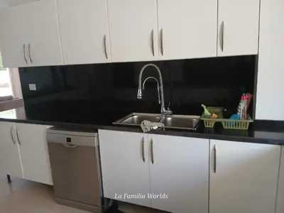 a kitchen counter with a sink and white cabinets at Holiday Villa in Hurhgada Egypt in Hurghada